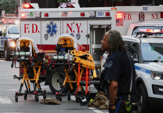 Stretchers are prepared as emergency services gather during a reported active shooter situation in the Manhattan borough of New York City July 28, 2025. The shooting at a midtown Manhattan office building left multiple people dead, including an off-duty New York City police officer, sources told the The Associated Press. 