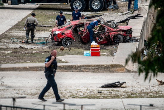 First responders attend to a vehicle pulled from the water in the aftermath of deadly flooding in Kerrville, Texas, July 6, 2025. At least 82 people are dead and at least 41 more are missing after devastating flash floods slammed the Texas Hill Country, with water rescues taking place along the Guadalupe River, which rose rapidly early July 4 to the height of a two-story building. Among the missing were almost a dozen from Camp Mystic in Kerr County, a children's summer camp, officials said July 6.
