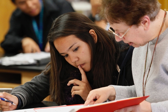 A teacher is pictured in a file photo working with a student in science class at St. Michael Indian School in St. Michaels, Ariz. Experts and teachers from coast to coast told OSV News that artificial intelligence, AI, is poised to transform Catholic education.