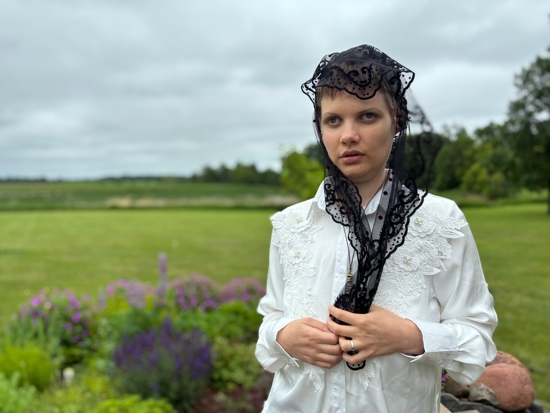 Claire Souilliart of Calais, France, stands in a garden June 14, 2025, near Stacy, Minn., after recounting her claims of two miraculous visits from Sister Annella Zervas, a Minnesota Benedictine whose cause for canonization may open soon, leading her to be cured of a blood disorder.