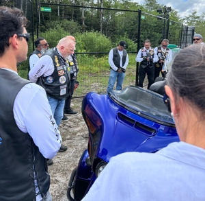 Motorcycles ridden by Archbishop Thomas G. Wenski of Miami and Knights on Bikes are parked in front of the entrance to Alligator Alcatraz, a controversial immigration detention facility some 55 miles from Miami in the Florida Everglades. The archbishop and his fellow bikers stopped to pray a rosary for detainees July 20, 2025.