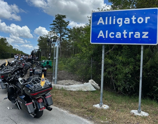 Archbishop Thomas G. Wenski of Miami and Knights on Bikes pray the rosary for detainees at the entrance to Alligator Alcatraz, a controversial immigration detention facility in some 55 miles from Miami in the Florida Everglades, July 20, 2025.