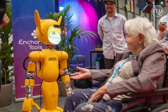 A woman in a wheelchair reaches out to Mirokaï, a new generation of robots that employs Artificial Intelligence, as seen in this photo take July 8, 2025, at the AI for Good Summit 2025 in Geneva. The July 8-11 summit, organized by the International Telecommunication Union in partnership with some 40 U.N. agencies and the Swiss government, focused on "identifying innovative AI applications, building skills and standards, and advancing partnerships to solve global challenges," according to the event's website.