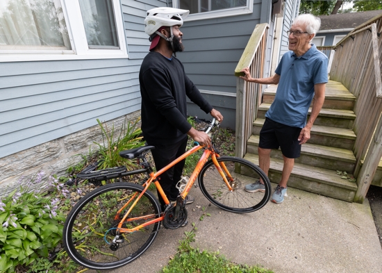Dave Haley, right, board chair of Casa Guadalupana in St. Paul, talks with Andre, a resident.