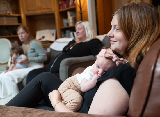 Tarah Hazard holds her daughter, Evelyn, during an Aug. 8 gathering of a mothers’ small group at St. Peter in North St. Paul. The moms meet twice a month in the home of Krysten Fulcher, the group's leader.