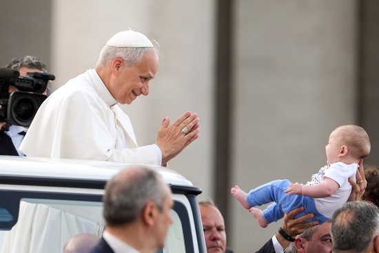 Pope Leo XIV greets a child from the popemobile as he prepares to lead a Pentecost prayer vigil in St. Peter's Square at the Vatican June 7, 2025, with participants in the Jubilee of Ecclesial Movements, Associations and New Communities.