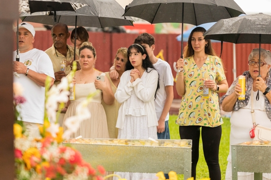 Pilgrims brave heavy rain to place flowers and pray Sept 8, 2025, at the the National Shrine of Our Lady of Charity in Miami, affectionately known as La Ermita de La Caridad, for the annual feast of Our Lady of Charity and the 25th anniversary of La Ermita's designation as a national shrine by the U.S. Conference of Catholic Bishops in 2000.