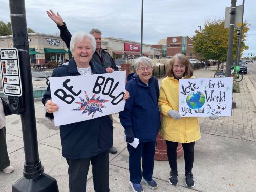 Lumen Christi parishioners hold signs at St. Paul intersection encouraging people to vote