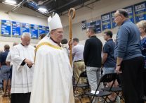 Archbishop Bernard Hebda processes out of the gym at Academy of Holy Angels in Richfield following a prayer service Aug. 27 in the hours following a shooting at Annunciation’s church in Minneapolis.