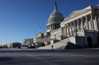 A person walks past the Senate side of the U.S. Capitol building.