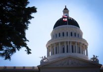 U.S. and California flags fly in front of the dome of the California Capitol in Sacramento May 9, 2019. Catholics have lauded Gov. Gavin Newsom's July 30 signing of a state law that makes it a felony to procure sex from a 16- or 17-year-old minor in the state of California.
