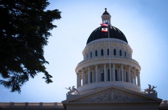 U.S. and California flags fly in front of the dome of the California Capitol in Sacramento May 9, 2019. Catholics have lauded Gov. Gavin Newsom's July 30 signing of a state law that makes it a felony to procure sex from a 16- or 17-year-old minor in the state of California.