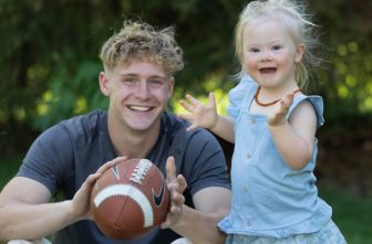 Cameron Begalle enjoys some play time with his youngest sister, Evie, in the backyard of the family’s home in Andover.