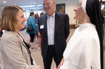 Judy Logan, left, managing director at Emmaus Partners, talks with Sister Maria Ivana Begovic, right, principal of St. Croix Catholic School in Stillwater, and Al Erickson, previous managing director at Emmaus (2011-2021), before Mass July 15 at St. Peter in Mendota to celebrate the 25th anniversary of Emmaus Partners.  DAVE HRBACEK  |  THE CATHOLIC SPIRIT
