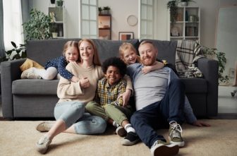 An advertisement for Catholic Charities Community Services depicts a foster care family.