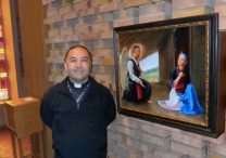 Father Toulee Peter Ly, pastor of Presentation of the Virgin Mary in Maplewood, stands beside a painting of “Hmong Mary” in the church. The painting was commissioned by Father Joseph Johnson, rector of the Cathedral of St. Paul and former pastor of St. Vincent de Paul, a former home of the Hmong Catholic community that was part of the Cathedral community.