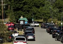 Law enforcement officers gather at Cherry Hill Park after multiple firefighters were attacked when responding to a fire in the Canfield Mountain area outside Coeur d'Alene, Idaho, June 29, 2025. Two firefighters were killed and at least one other was wounded when they were ambushed by sniper fire while responding to a blaze in a northern Idaho mountain community, as crews endured a barrage of gunfire over several hours that the governor called a "heinous" assault.