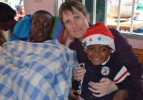 Gena Heraty, a longtime Irish missionary in Haiti, is pictured with children in a 2014 photo. Heraty was among several people -- including a three-year-old child -- taken in the early hours of Aug. 3, 2025, after gunmen breached the Saint-Hélène orphanage in Kenscoff, near Haiti's capital of Port-au-Prince.
