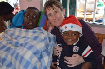 Gena Heraty, a longtime Irish missionary in Haiti, is pictured with children in a 2014 photo. Heraty was among several people -- including a three-year-old child -- taken in the early hours of Aug. 3, 2025, after gunmen breached the Saint-Hélène orphanage in Kenscoff, near Haiti's capital of Port-au-Prince.