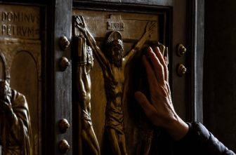 The Jubilee Year with its theme Pilgrims of Hope included the Jubilee of the Sick and Health Care Workers at the Vatican April 5-6. In this photo, a pilgrim places a hand on the Holy Door of St. Peter's Basilica on the first day of the Jubilee event.