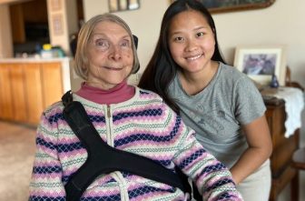 Jean Swenson, left, with her personal care assistant, Pa Di Moua, in Swenson’s apartment in St. Paul.