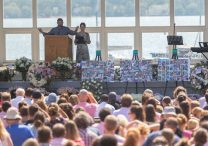 Harper Moyski’s parents, Mike Moyski and Jackie Flavin, address those gathered for Harper’s memorial service at the Lake Harriet Bandshell in Minneapolis Sept. 14. Harper was one of two students at Annunciation Catholic School in Minneapolis who died in the Aug. 27 shooting at Annunciation church.  DAVE HRBACEK  |  THE CATHOLIC SPIRIT