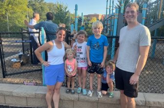 From left, Mallory O’Brien and her family, Mollie, Finley, Conor, Emmett, and husband, Sean, at Annunciation school’s playground after the Aug. 30 Mass. The O’Briens said the parish will recover after the Aug. 27 shooting. JOE RUFF  | THE CATHOLIC SPIRIT