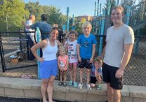 From left, Mallory O’Brien and her family, Mollie, Finley, Conor, Emmett, and husband, Sean, at Annunciation school’s playground after the Aug. 30 Mass. The O’Briens said the parish will recover after the Aug. 27 shooting. JOE RUFF  | THE CATHOLIC SPIRIT