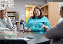 From left, Greg DeBenedetto, Christina Kraus and Brian Busch talk during their small group meeting May 28 at St. Hubert in Chanhassen. All are parishioners. DeBenedetto leads the group.