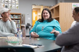From left, Greg DeBenedetto, Christina Kraus and Brian Busch talk during their small group meeting May 28 at St. Hubert in Chanhassen. All are parishioners. DeBenedetto leads the group.