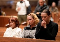 A young woman prays at Holy Name Cathedral in Chicago May 8, 2025. The Pew Research Center released a June 16, 2025, analysis of U.S. Catholic life.