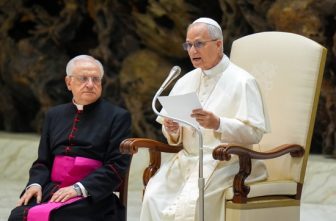 Pope Leo XIV talks to visitors during his weekly general audience in the Paul VI Audience Hall at the Vatican Aug. 20, 2025.