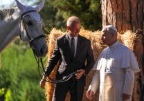Pope Leo XIV looks at a horse as he greets an employee of the papal gardens in Castel Gandolfo, Italy, Sept. 5, 2025. The pope inaugurated Borgo Laudato Si' the same day, officially opening the historic papal residence as a center dedicated to the principles of care for creation and human dignity outlined in Pope Francis' encyclical Laudato Si'.