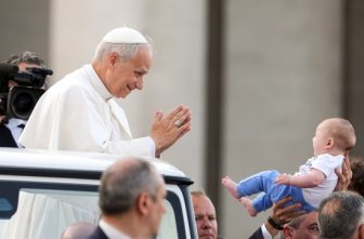 Pope Leo XIV greets a child from the popemobile as he prepares to lead a Pentecost prayer vigil in St. Peter's Square at the Vatican June 7, 2025, with participants in the Jubilee of Ecclesial Movements, Associations and New Communities.