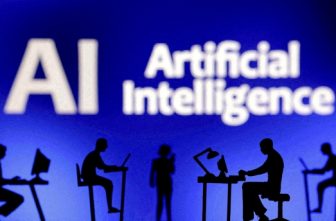 Figurines with computers and smartphones are seen in front of the words "AI Artificial Intelligence" in this Feb. 19, 2024, illustration.