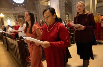From left, lectors Naomi Hasegawa, Julie Le and Marzena Laugen join the processional for the Extended Vigil Mass of Pentecost at the Cathedral of St. Paul in St. Paul June 7.  DAVE HRBACEK  |  THE CATHOLIC SPIRIT