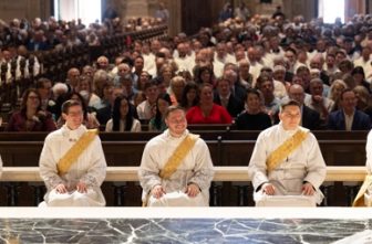 From left, Deacons Randy Skeate, Zachary Ochsenbauer, Alexander Marquette, Benjamin Eichten and Stephen Boatwright listen to Archbishop Hebda during the homily just before their ordination to the priesthood May 31 at the Cathedral of St. Paul in St. Paul.  DAVE HRBACEK  |  THE CATHOLIC SPIRIT