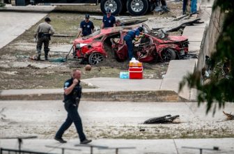 First responders attend to a vehicle pulled from the water in the aftermath of deadly flooding in Kerrville, Texas, July 6, 2025. At least 82 people are dead and at least 41 more are missing after devastating flash floods slammed the Texas Hill Country, with water rescues taking place along the Guadalupe River, which rose rapidly early July 4 to the height of a two-story building. Among the missing were almost a dozen from Camp Mystic in Kerr County, a children's summer camp, officials said July 6.