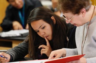 A teacher is pictured in a file photo working with a student in science class at St. Michael Indian School in St. Michaels, Ariz. Experts and teachers from coast to coast told OSV News that artificial intelligence, AI, is poised to transform Catholic education.