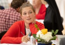 Alanna Halloran of Our Lady of Grace in Edina listens during an afternoon session of the Archdiocesan Synod 2025 Be My Witnesses Assembly June 7 at Cretin-Derham Hall high school in St. Paul.