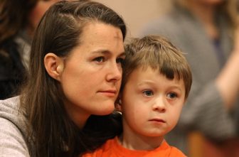 A file photo shows a mother and son listening to the homily during Ash Wednesday Mass in the chapel at the Franciscan Monastery of the Holy Land in Washington. OSV News photo/Bob Roller
