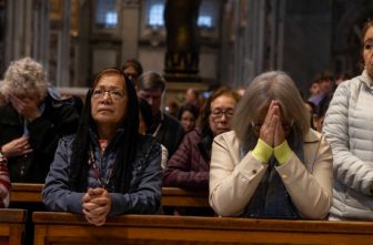 Pilgrims from the Diocese of Pittsburgh, the Diocese of San Bernardino, Calif., and St. Agnes School in St. Paul, Minn., receive Communion and pray during a Jubilee Mass at the Altar of the Chair in St. Peter's Basilica at the Vatican March 17, 2025.