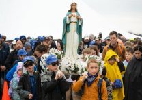 Children and adults wait for a two-mile "Walk with the Children" pilgrimage to begin at the National Shrine of Our Lady of Champion in Champion, Wis., May 6, 2023. Organizers of Walk to Mary, a 21-mile trek, began a walk for children in 2014 to allow more families to participate in the annual event.
