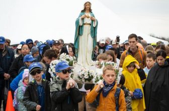 Children and adults wait for a two-mile "Walk with the Children" pilgrimage to begin at the National Shrine of Our Lady of Champion in Champion, Wis., May 6, 2023. Organizers of Walk to Mary, a 21-mile trek, began a walk for children in 2014 to allow more families to participate in the annual event.