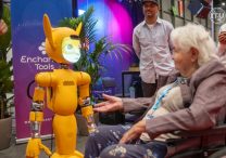 A woman in a wheelchair reaches out to Mirokaï, a new generation of robots that employs Artificial Intelligence, as seen in this photo take July 8, 2025, at the AI for Good Summit 2025 in Geneva. The July 8-11 summit, organized by the International Telecommunication Union in partnership with some 40 U.N. agencies and the Swiss government, focused on "identifying innovative AI applications, building skills and standards, and advancing partnerships to solve global challenges," according to the event's website.