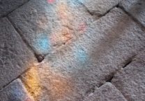 Stained glass reflection on stone floor