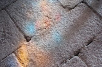 Stained glass reflection on stone floor